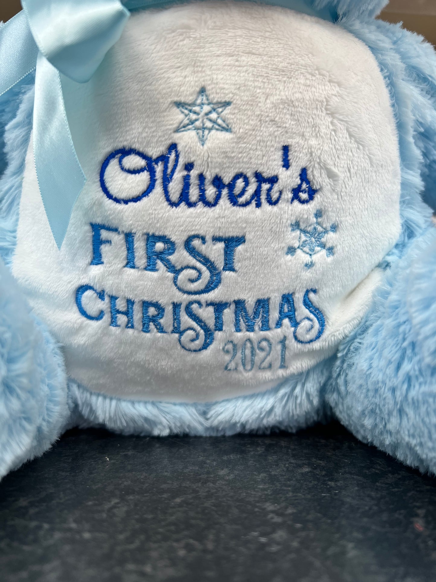 Personalised pastel blue teddy bear with embroidered name, featuring zipped bottom and removable inner pod for keepsakes or pyjamas