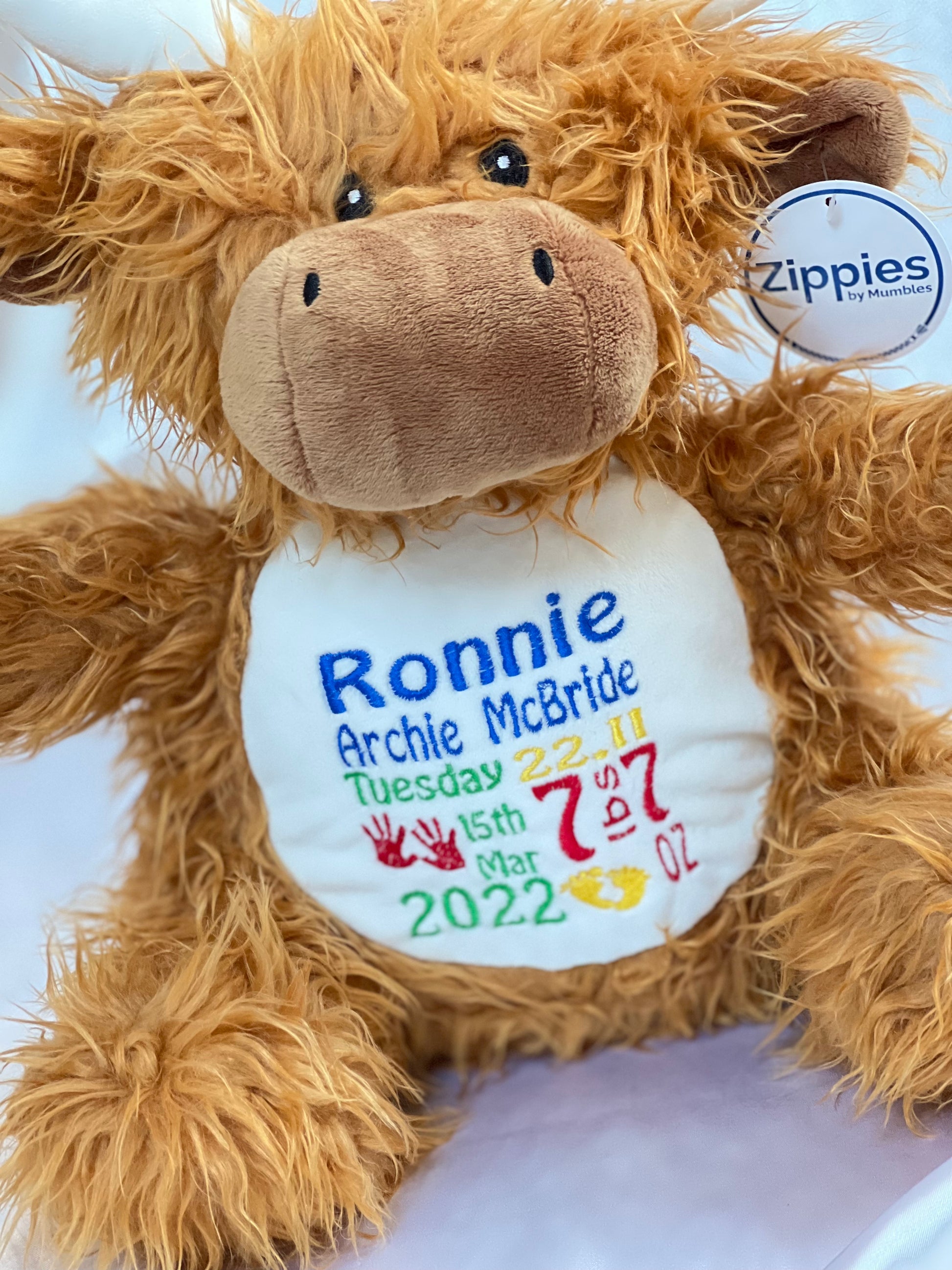 Soft plush highland cow toy with custom birth details