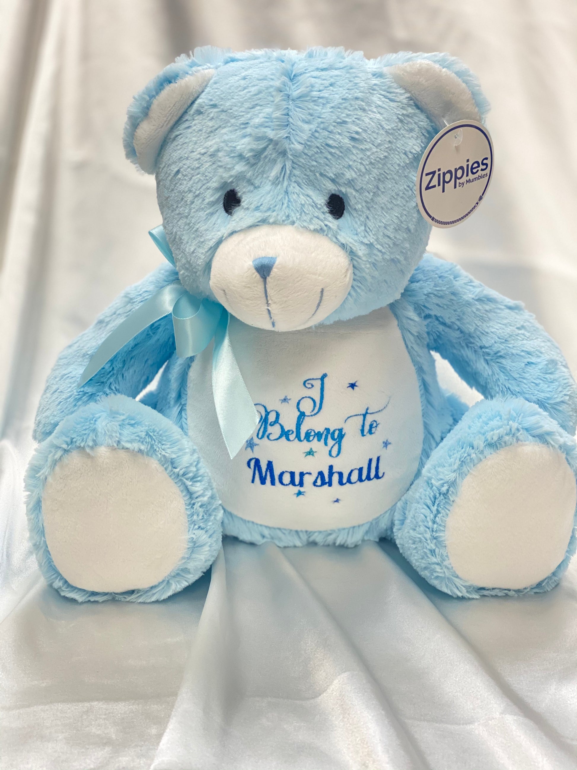 Personalised pastel blue teddy bear with embroidered name, featuring zipped bottom and removable inner pod for keepsakes or pyjamas