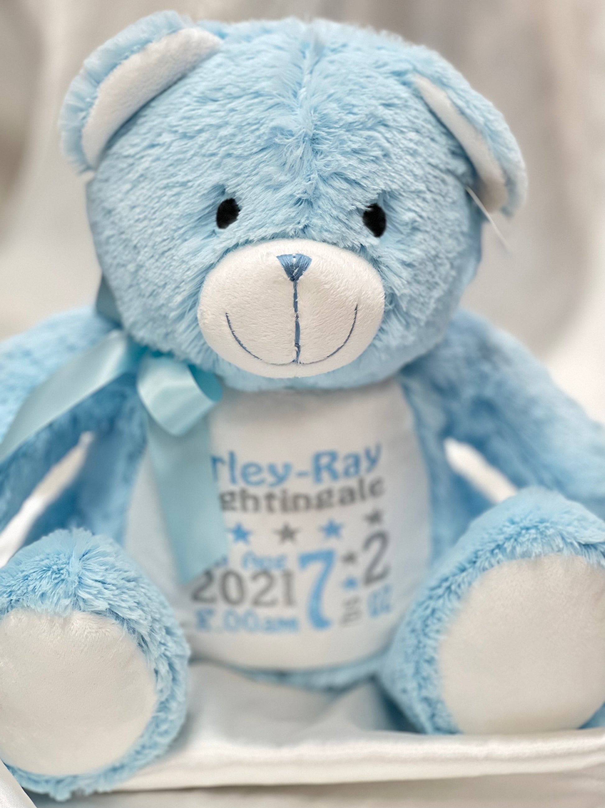 Personalised pastel blue teddy bear with embroidered name, featuring zipped bottom and removable inner pod for keepsakes or pyjamas