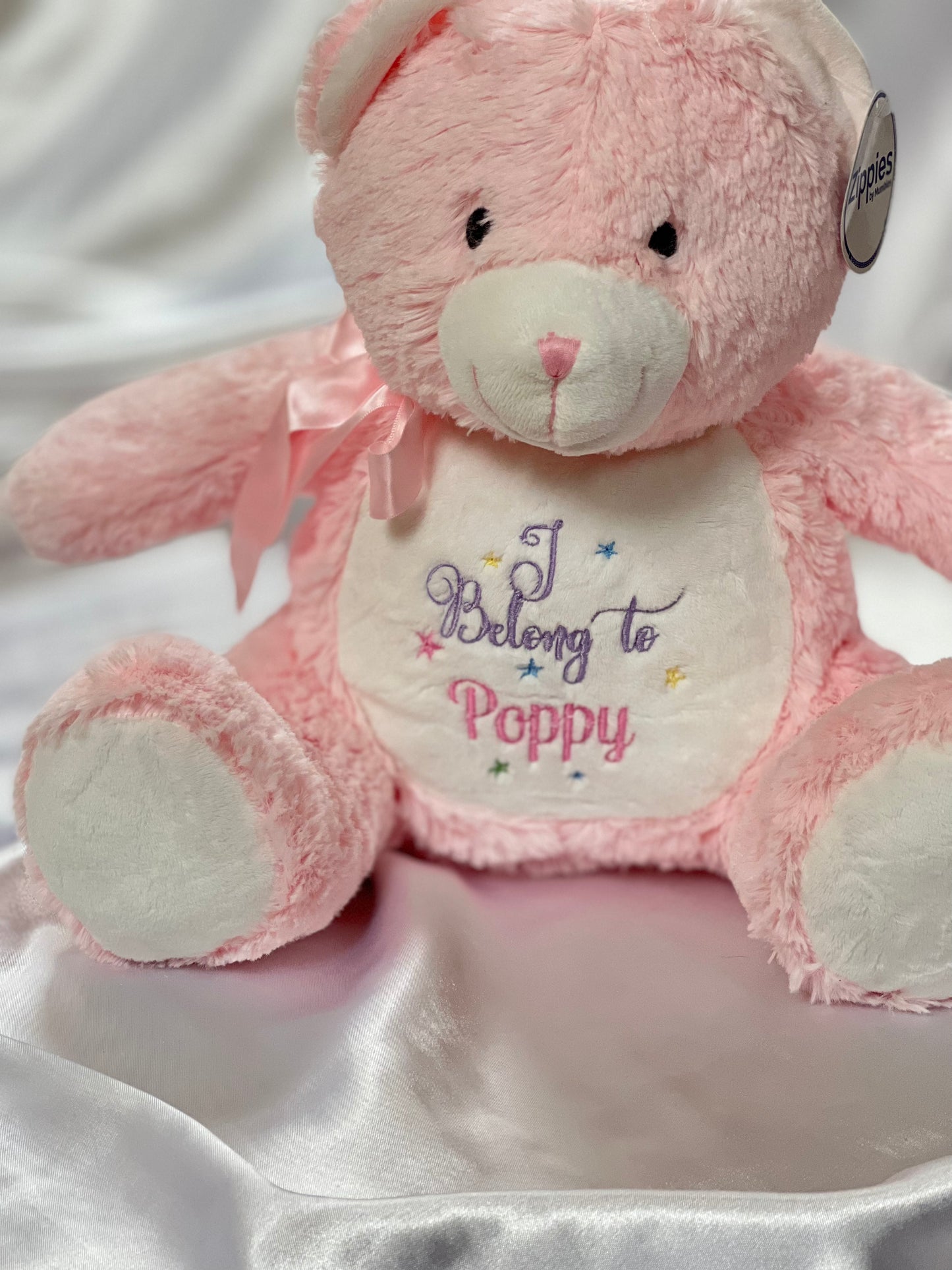 Personalised pink plush teddy bear with embroidered message, featuring zipped bottom and removable inner pod for keepsakes or pyjamas